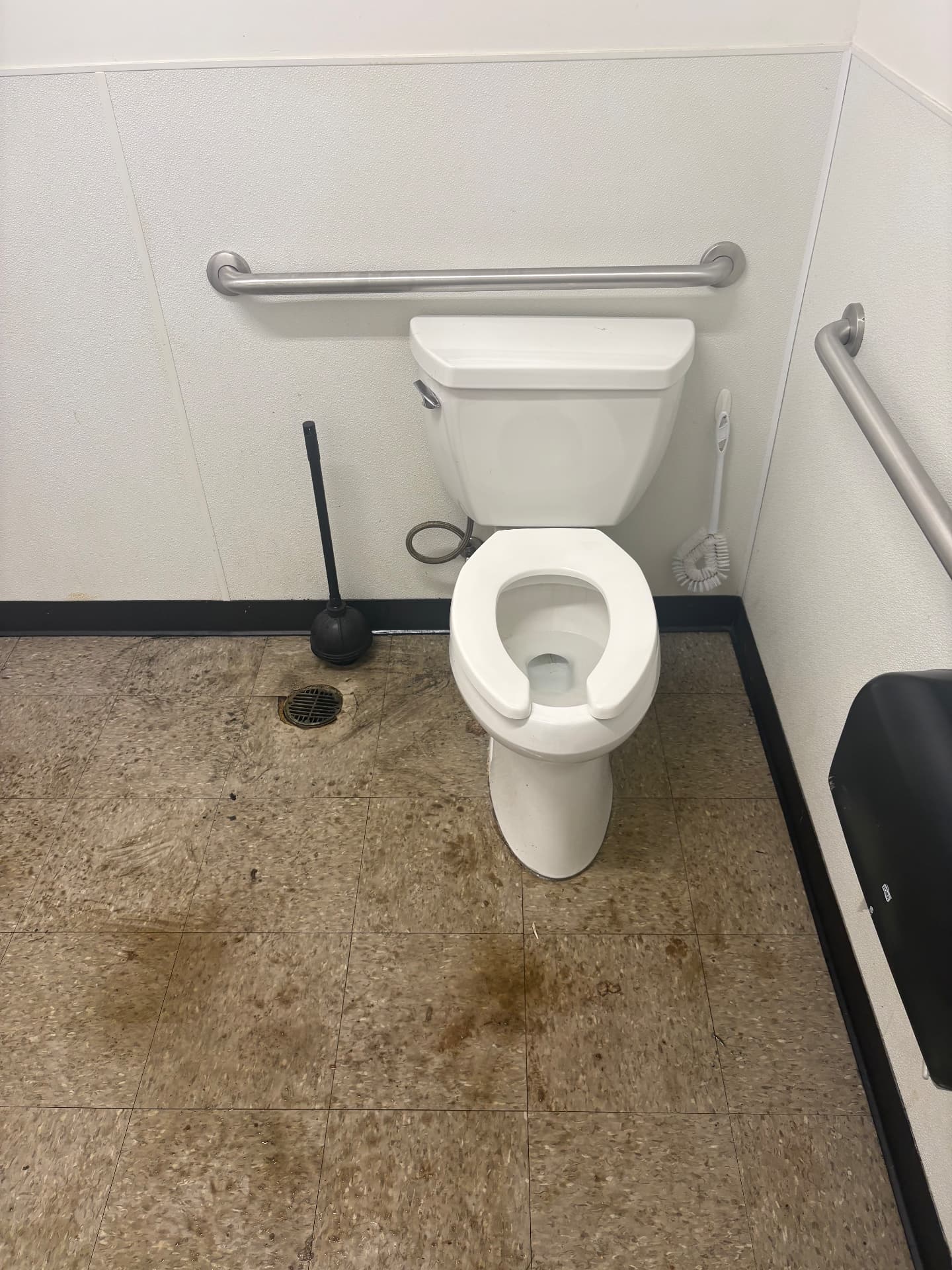 Commercial restroom post-plumbing cleanup before and after — before